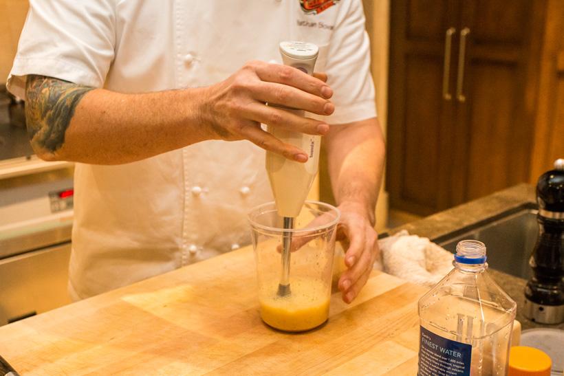 Slowly blending egg for hollandaise sauce