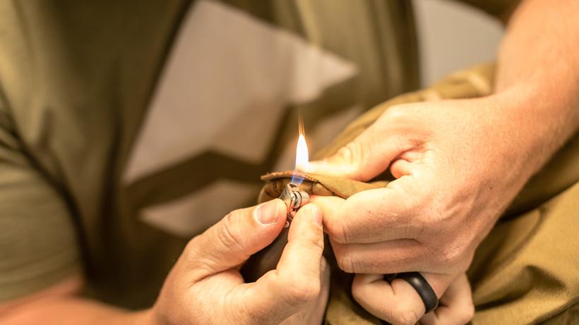 Burning the frayed ends of the straps