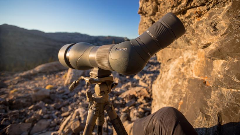 Angled vortex spotting scope glassing in mountain terrain with spotter rotated to the side for comfortable glassing