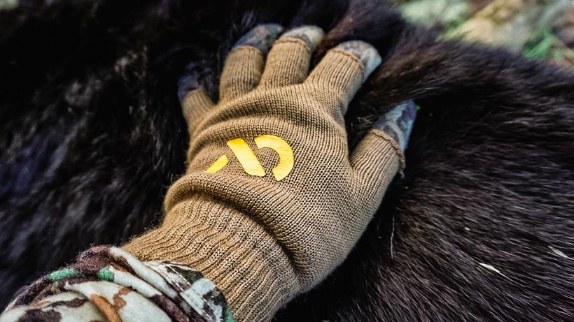 Hand on black bear hide
