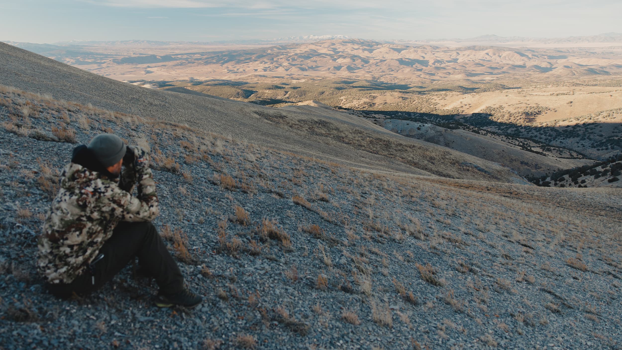 Trail Kreitzer glassing for mule deer on archery hunt