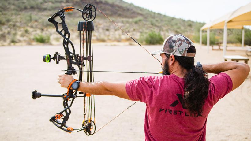 Hunter with full draw on bow