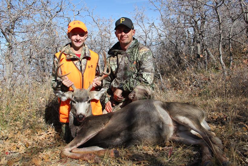 Father and daughter with the buck