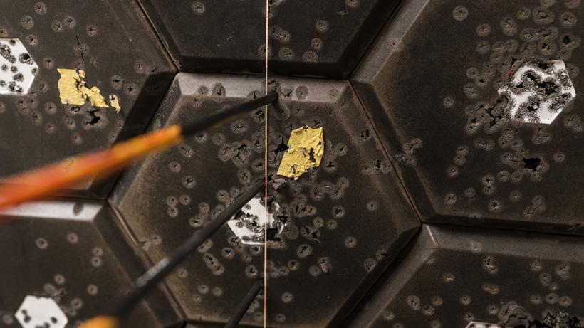 Archery bareshaft practice aiming at a string