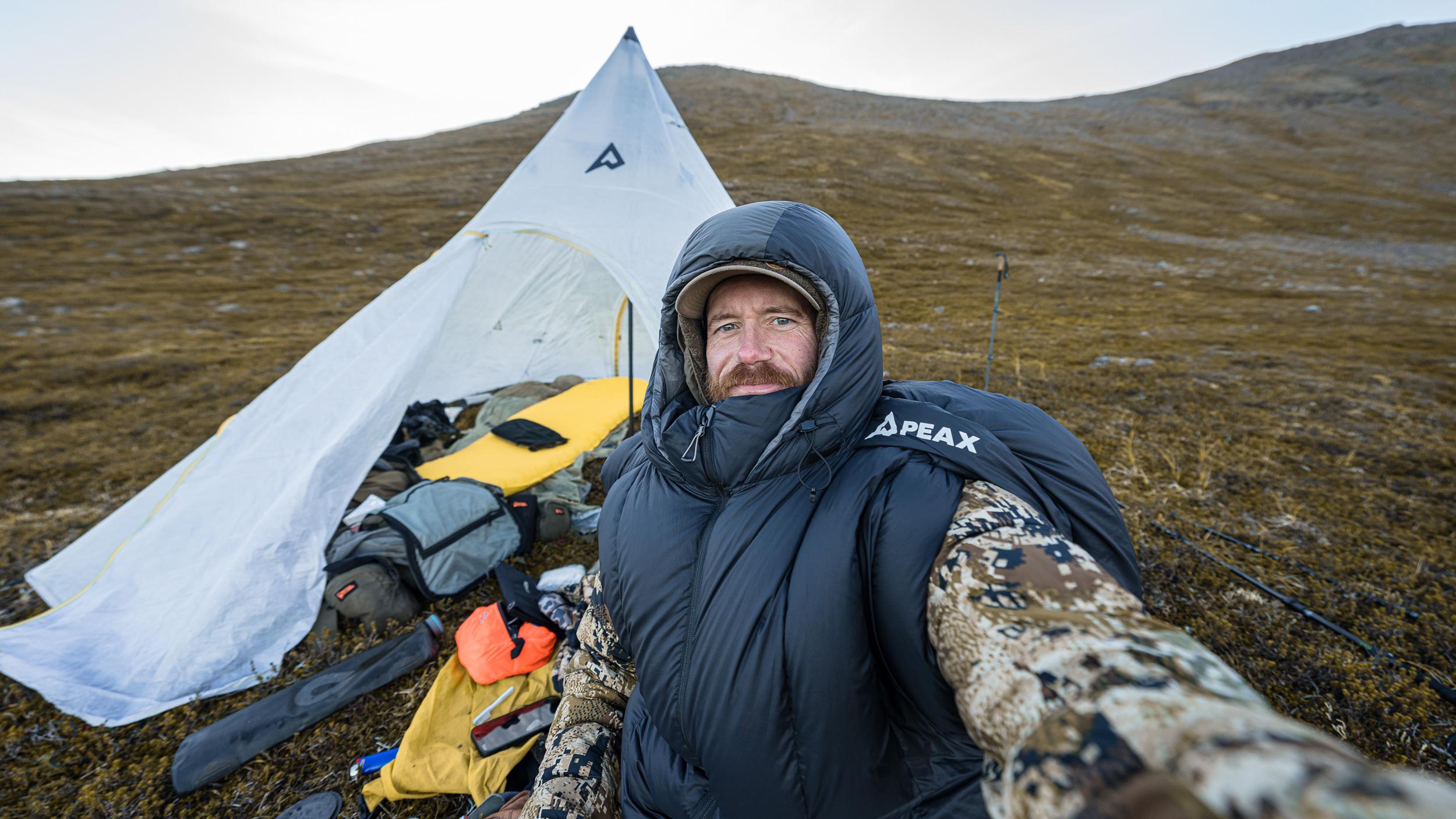 Brady Miller using PEAX SOLACE 15 degree sleeping bag on a mountain hunt