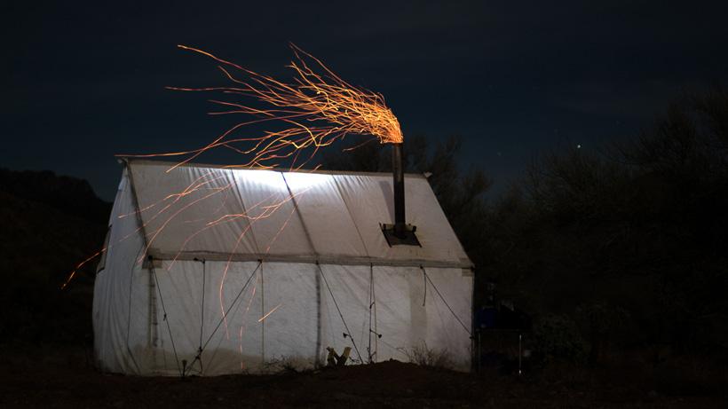 Wall tent photo at night with camp stove