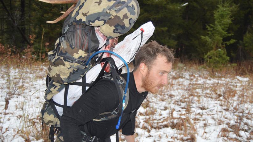 Justin klement packing out elk meat and gear
