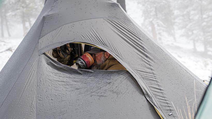 The unique door design allows you to enjoy a cup of coffee with a view or glass from inside the PEAX Solitude 4 Tipi shelter