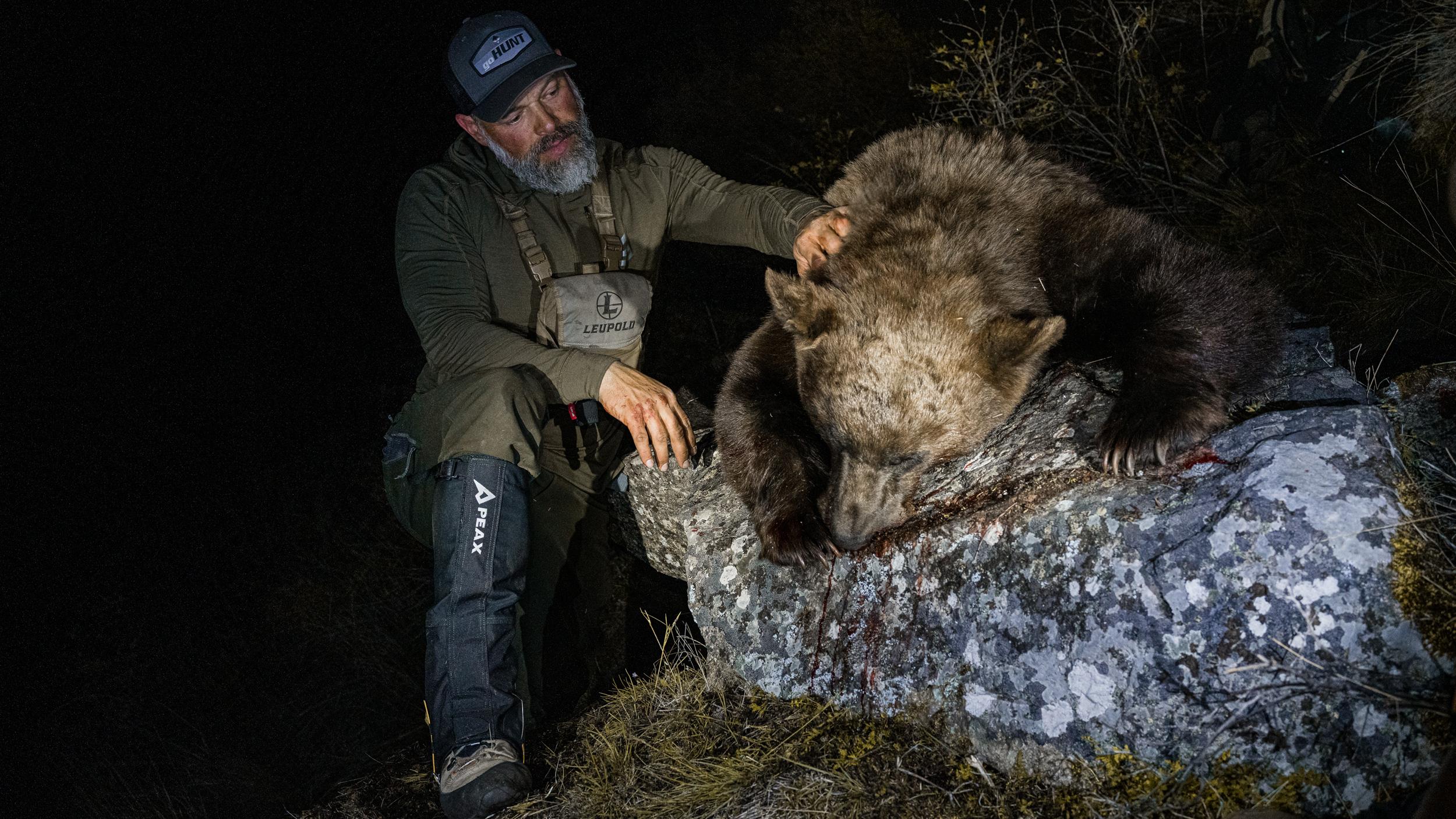 Brian Call with a black bear and PEAX Storm Castle boot gaiters