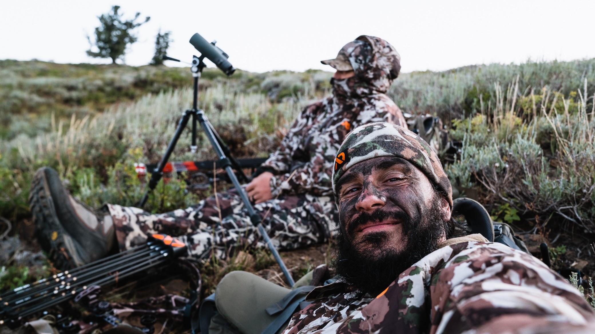Two hunters taking a break and relaxing in the bush