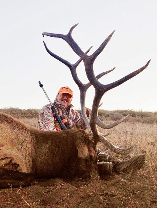 Bruce with an idaho bull elk taken with whiskey mountain outfitters