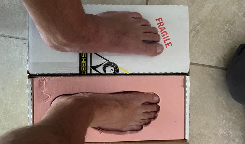 Jared placing foot in sheepfeet mold