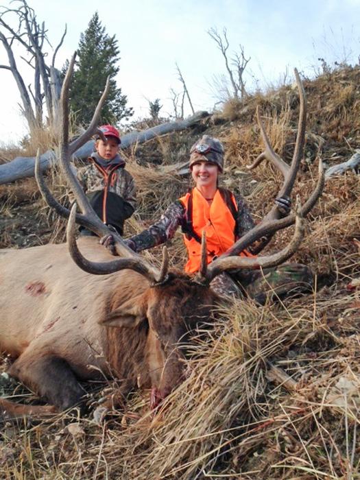 Deb with a large bull elk with tangle ridge outfitters
