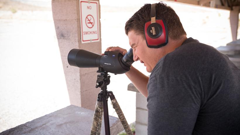 Hearing protection watching rifle bullet impact