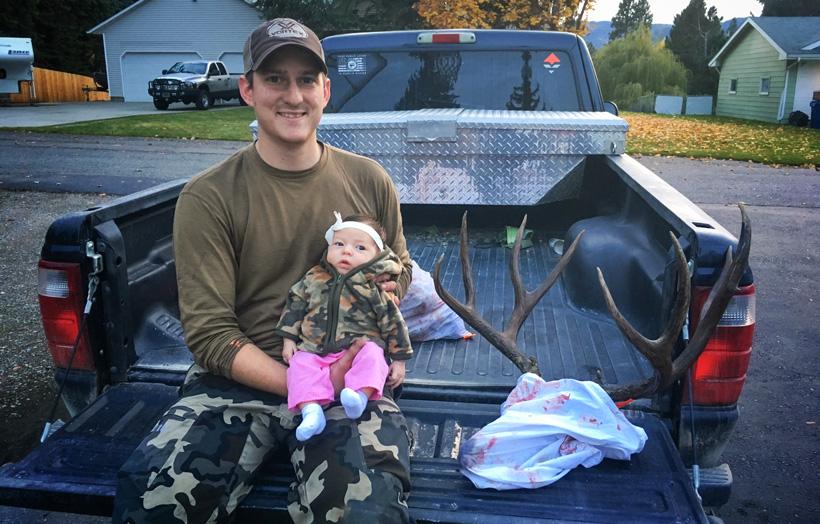 Dave barnett and newborn daughter with a montana mule deer