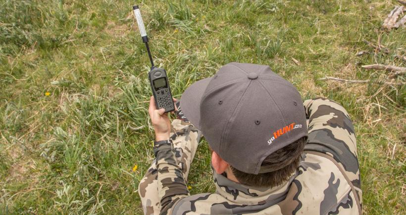 Using a satellite phone to check in while hunting