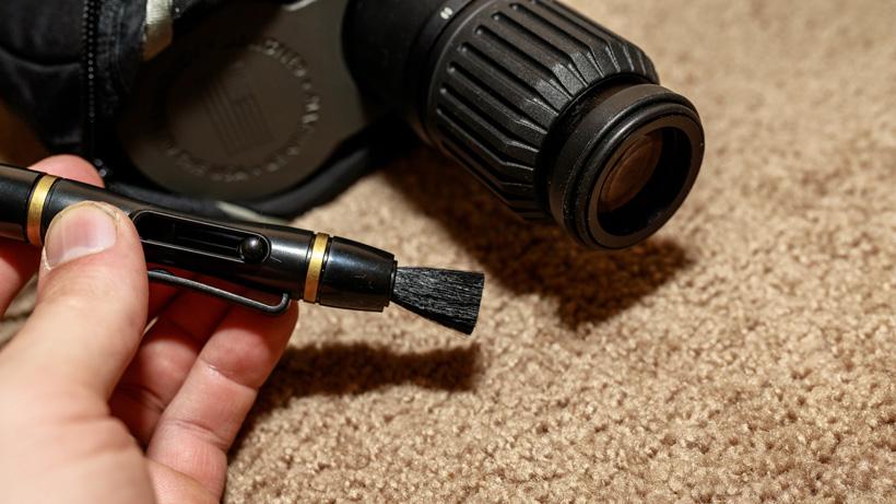 Cleaning hunting optics with lens pen brush
