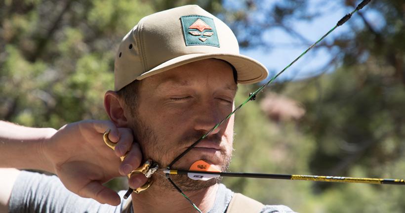 Closed eyes blank bale archery practice